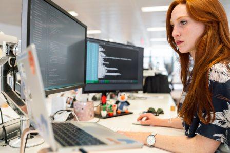 woman typing on computer in office